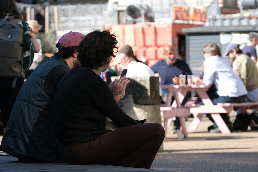 person using phone outdoors